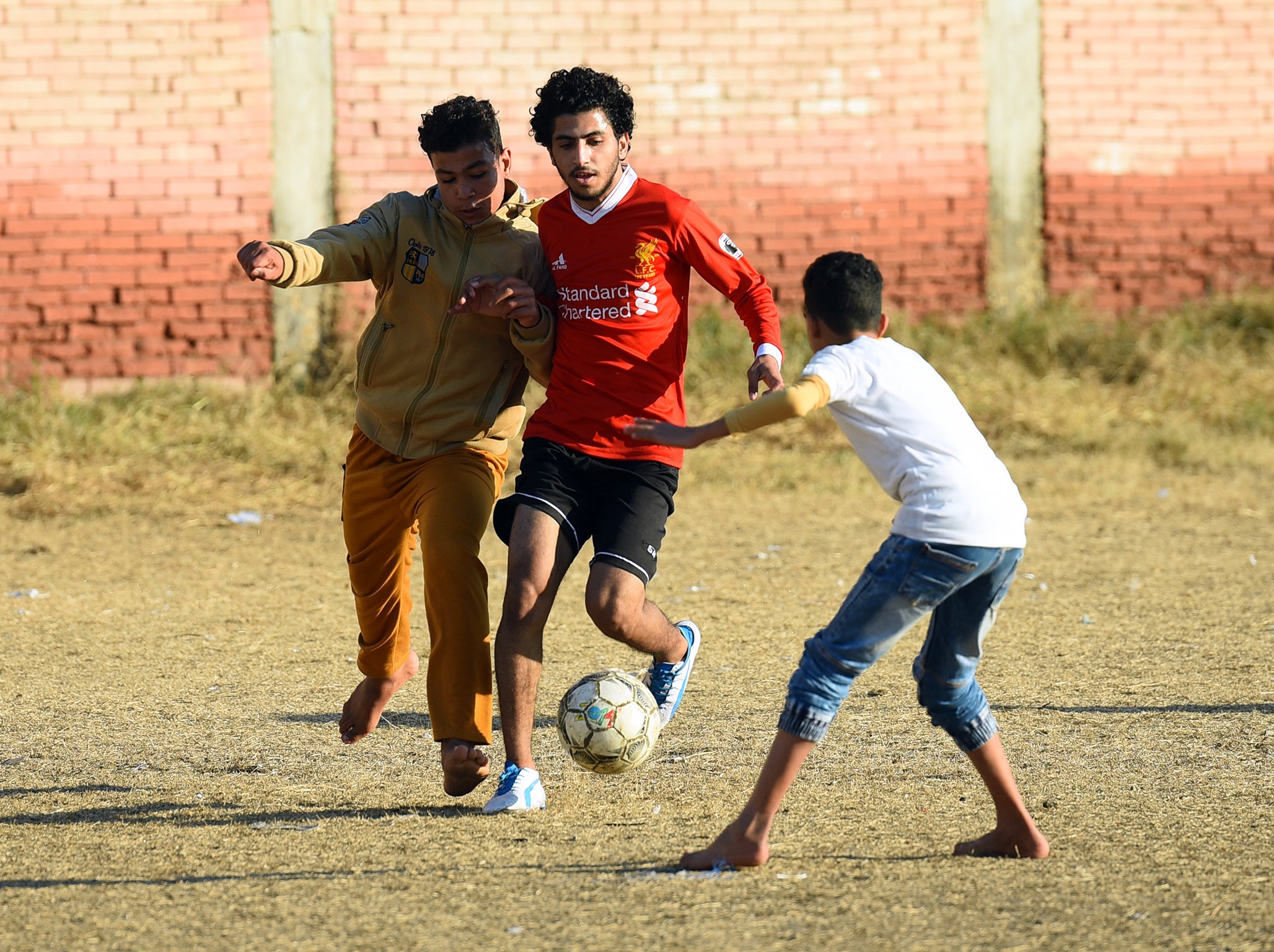 Kids enjoying a kickabout in Salah's hometown of Nagrig (Getty )