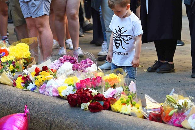 People paying their respects in central Manchester on the first anniversary of the attack