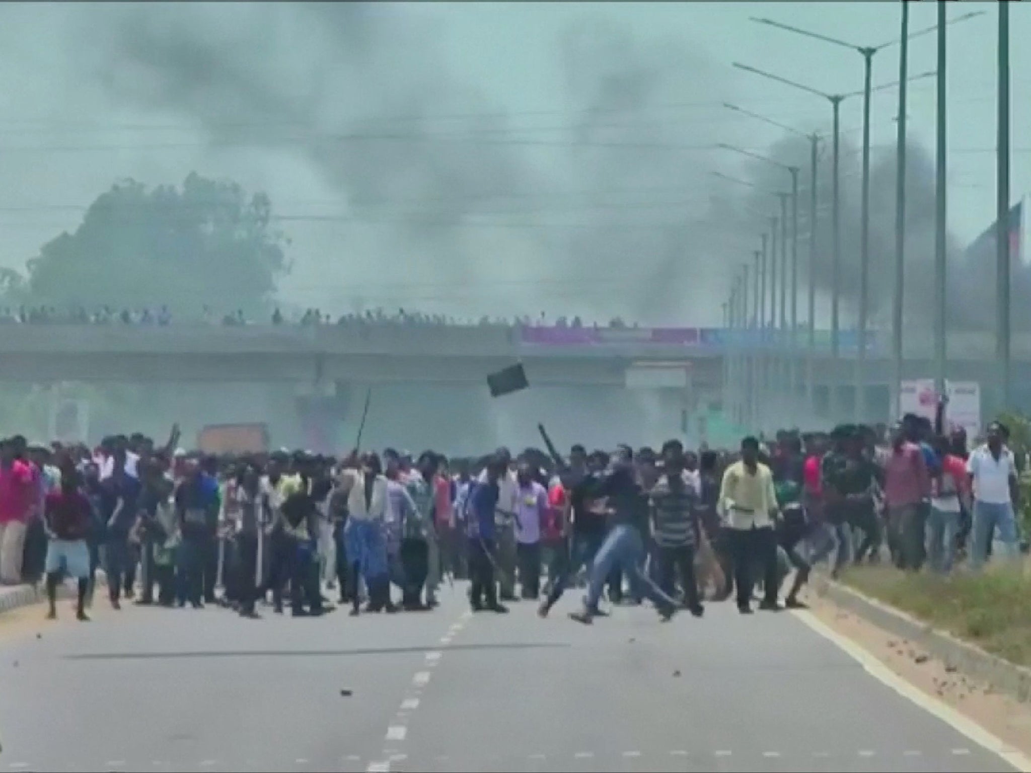 People throw stones during the protest