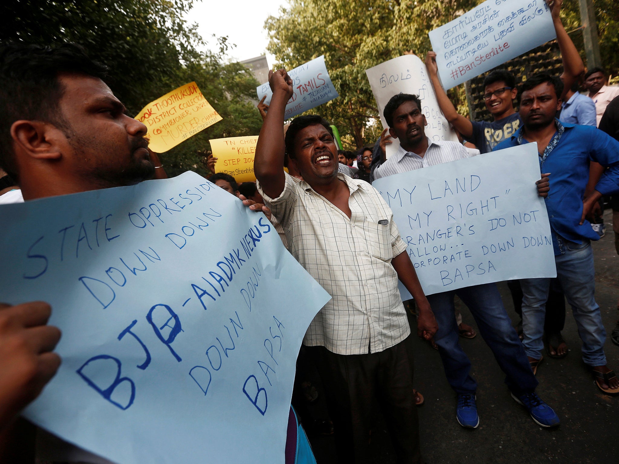 People shout slogans outside Tamil Nadu House during a protest, after at least 11 people were killed when police fired on protesters