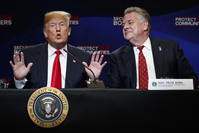 Representative Peter King, right, listens as President Donald Trump speaks during a roundtable on immigration policy