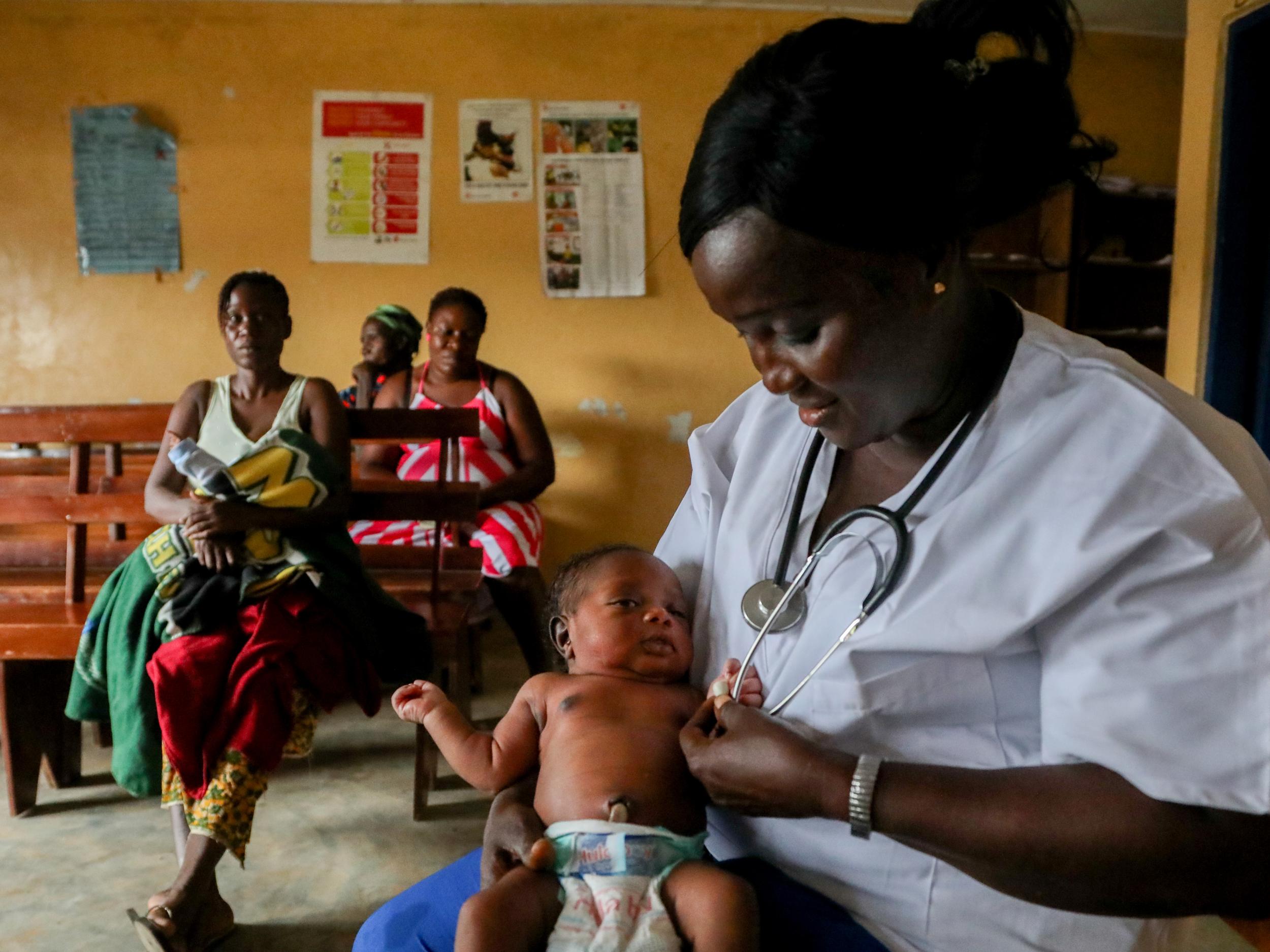 Alice Sumo holds two-day-old Alex at White Plains clinic near Monrovia, Liberia