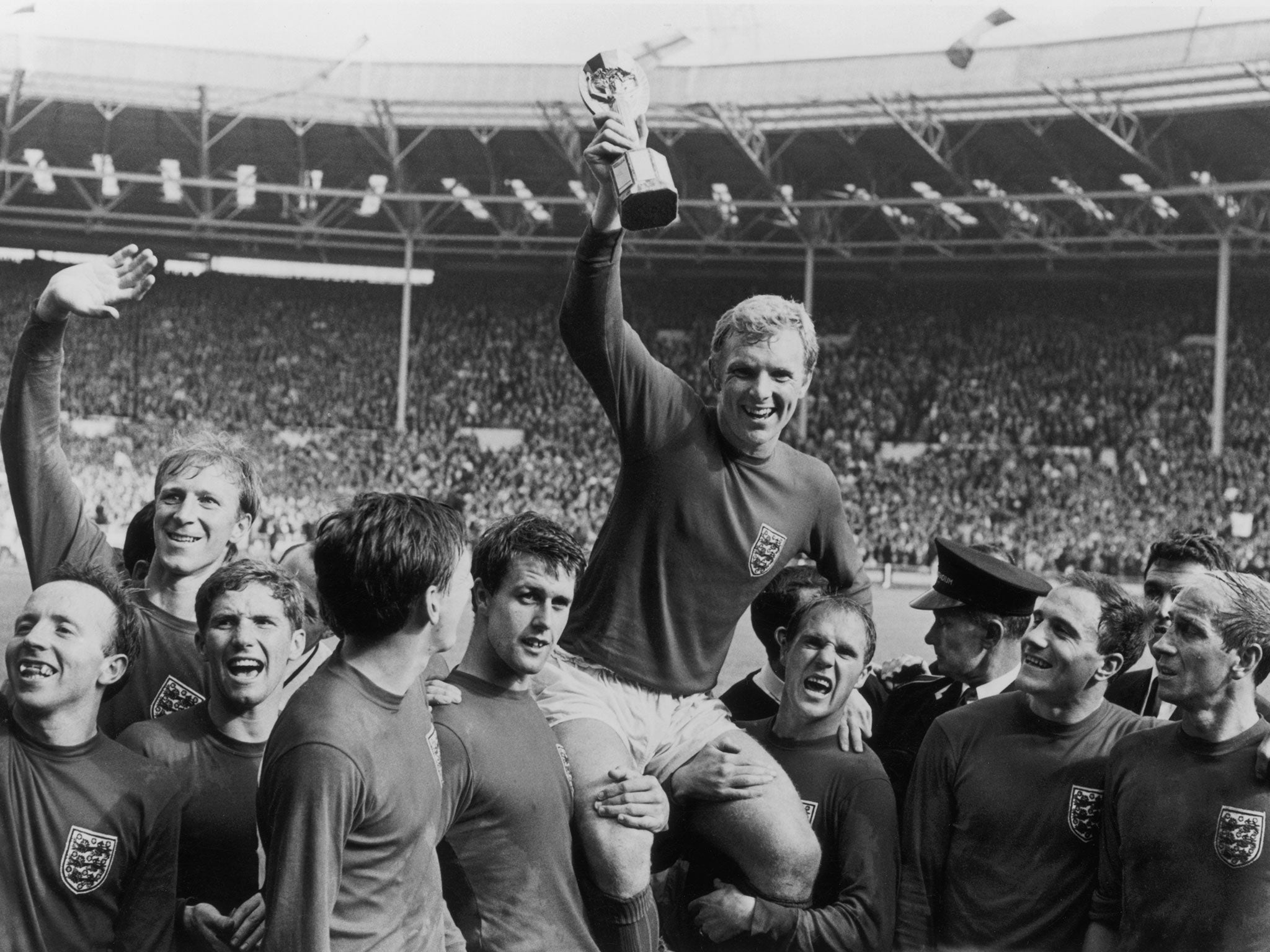 Bobby Moore holding aloft the Jules Rimet trophy as he is carried by his teammates following England’s victory over Germany in the 1966 World Cup final