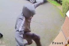 CCTV shows burglars kicking down door while girl cowers inside house