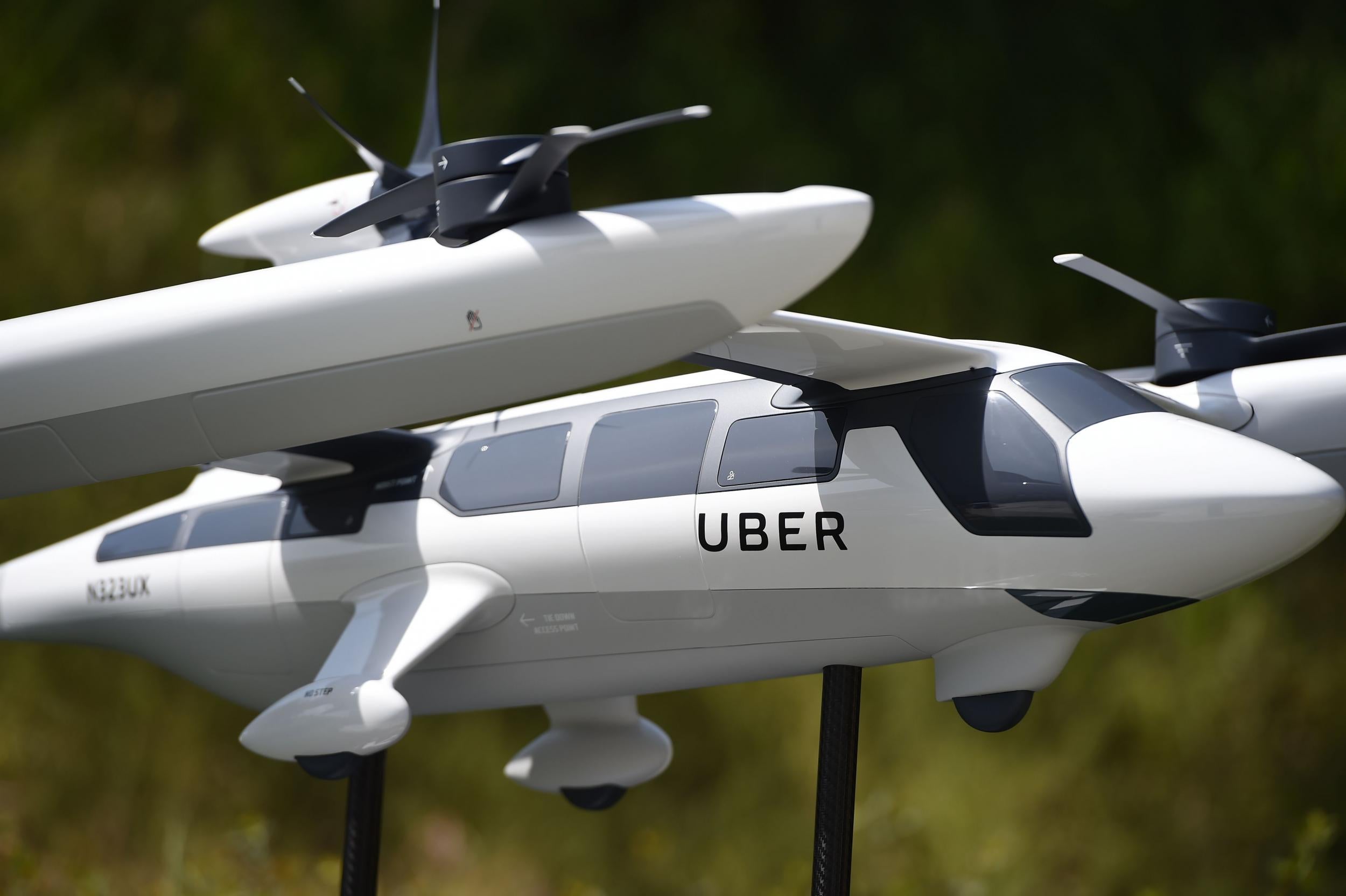A model of Uber's electric vertical take-off and landing vehicle concept (eVTOL) flying taxi is displayed at the second annual Uber Elevate Summit, on May 8, 2018 at the Skirball Center in Los Angeles, California. Uber introduced it's electric powered 'flying taxi' vertical take-off and landing concept aircraft at the event, which showcases prototypes for UberAir's fleet of airborne taxis.