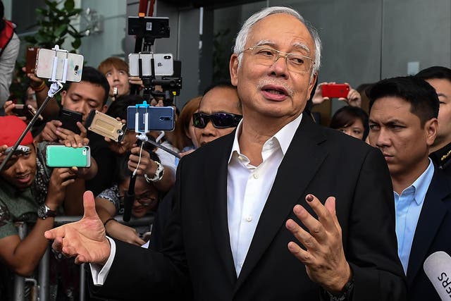 Malaysia's former prime minister Najib Razak speaks to the media after being questioned at the Malaysian Anti-Corruption Commission (MACC) office in Putrajaya