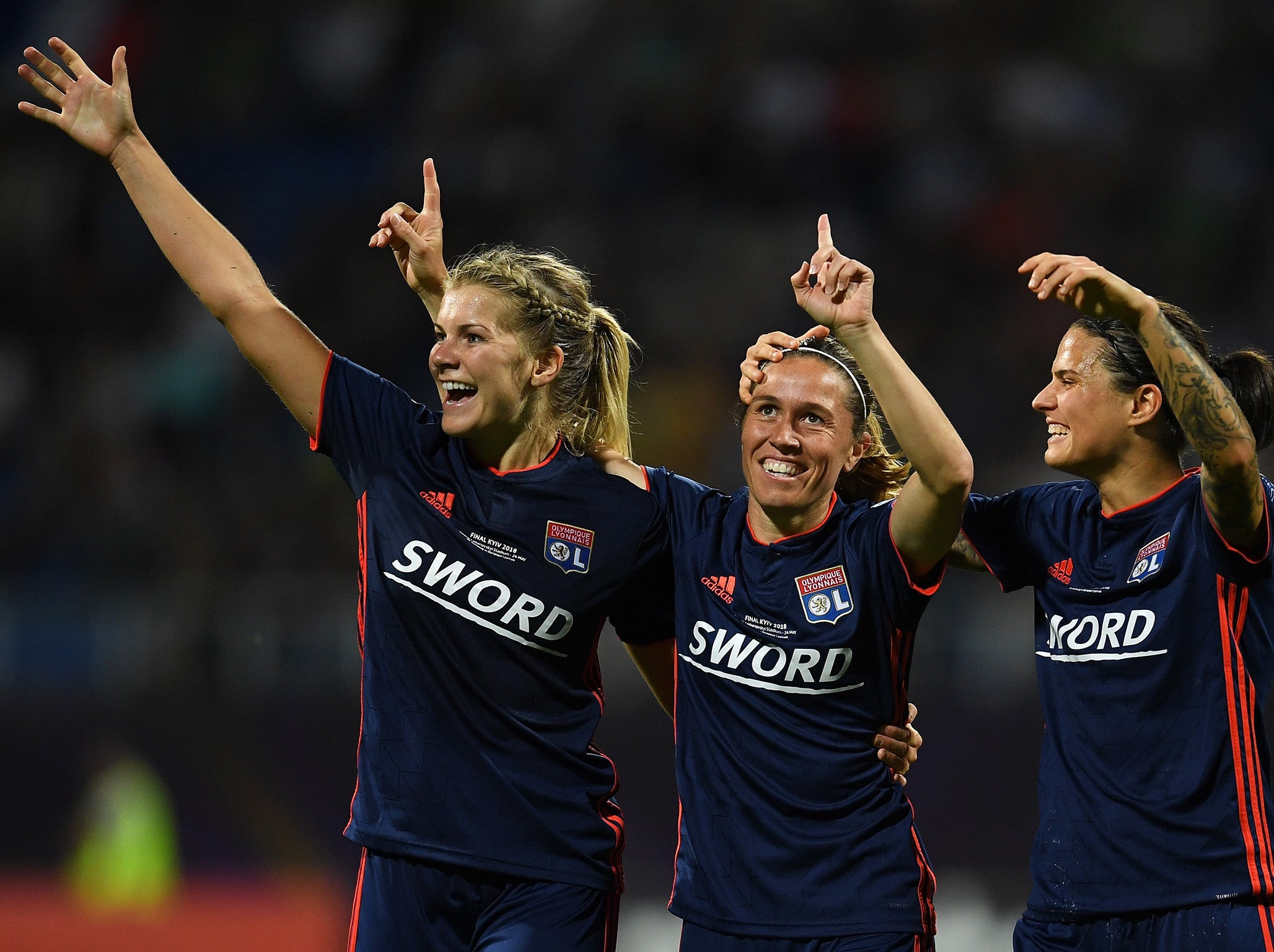 Camille Abily, centre, celebrates after scoring Lyon’s fourth goal