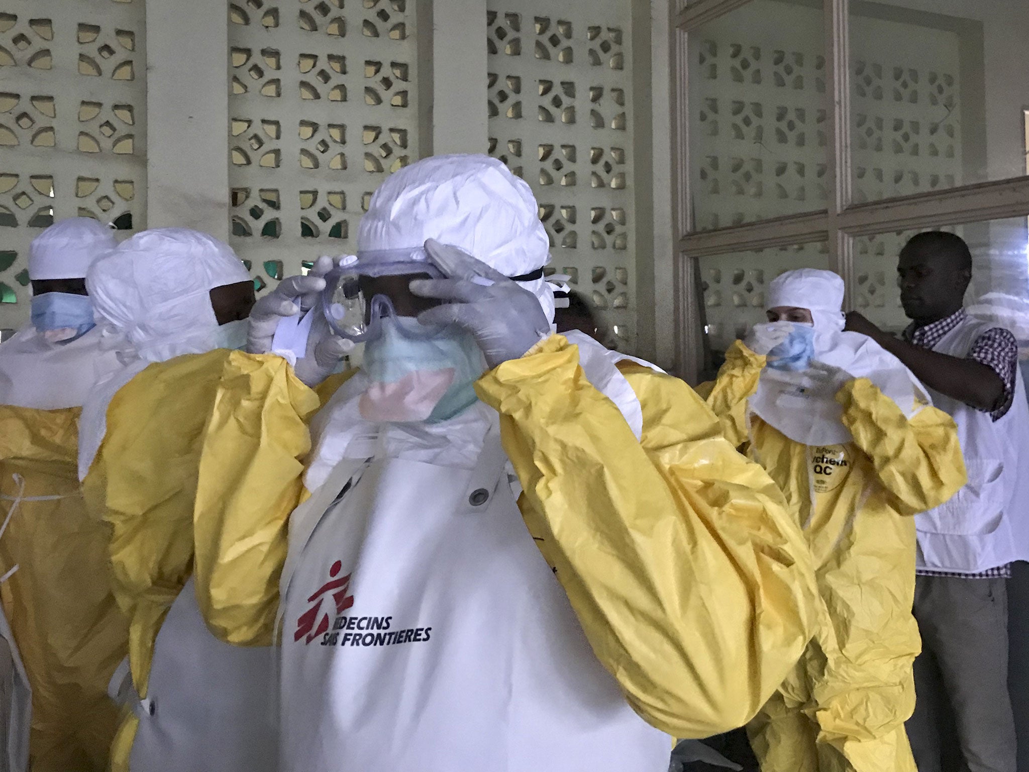 A team from Medecins Sans Frontieres (Doctors Without Borders) don protective clothing and equipment as they prepare to treat Ebola patients in an isolation ward of Mbandaka hospital in the Democratic Republic of the Congo