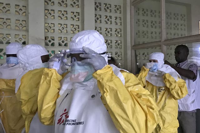 A team from Medecins Sans Frontieres (Doctors Without Borders) don protective clothing and equipment as they prepare to treat Ebola patients in an isolation ward of Mbandaka hospital in the Democratic Republic of the Congo