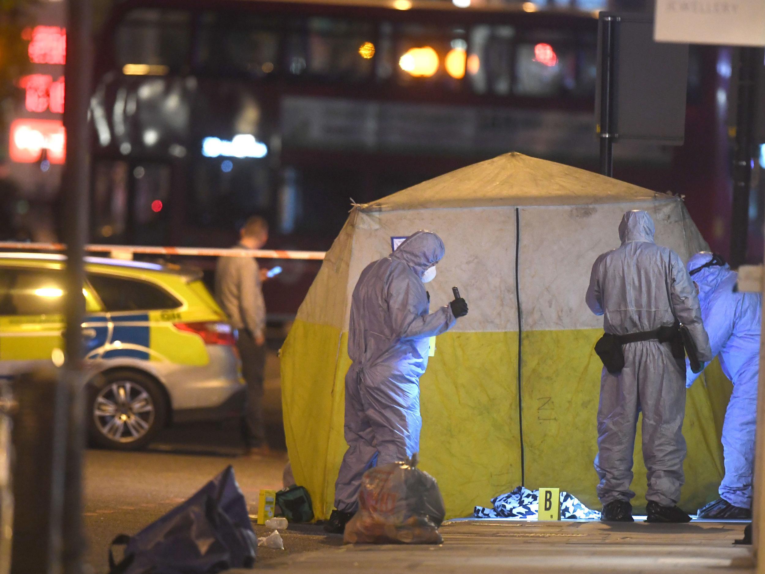 Forensics officers in Upper Street, Islington, after a man was stabbed to death