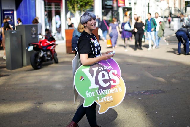 A Yes campaigner carries a placard in Dublin as Ireland holds a referendum on liberalising abortion laws