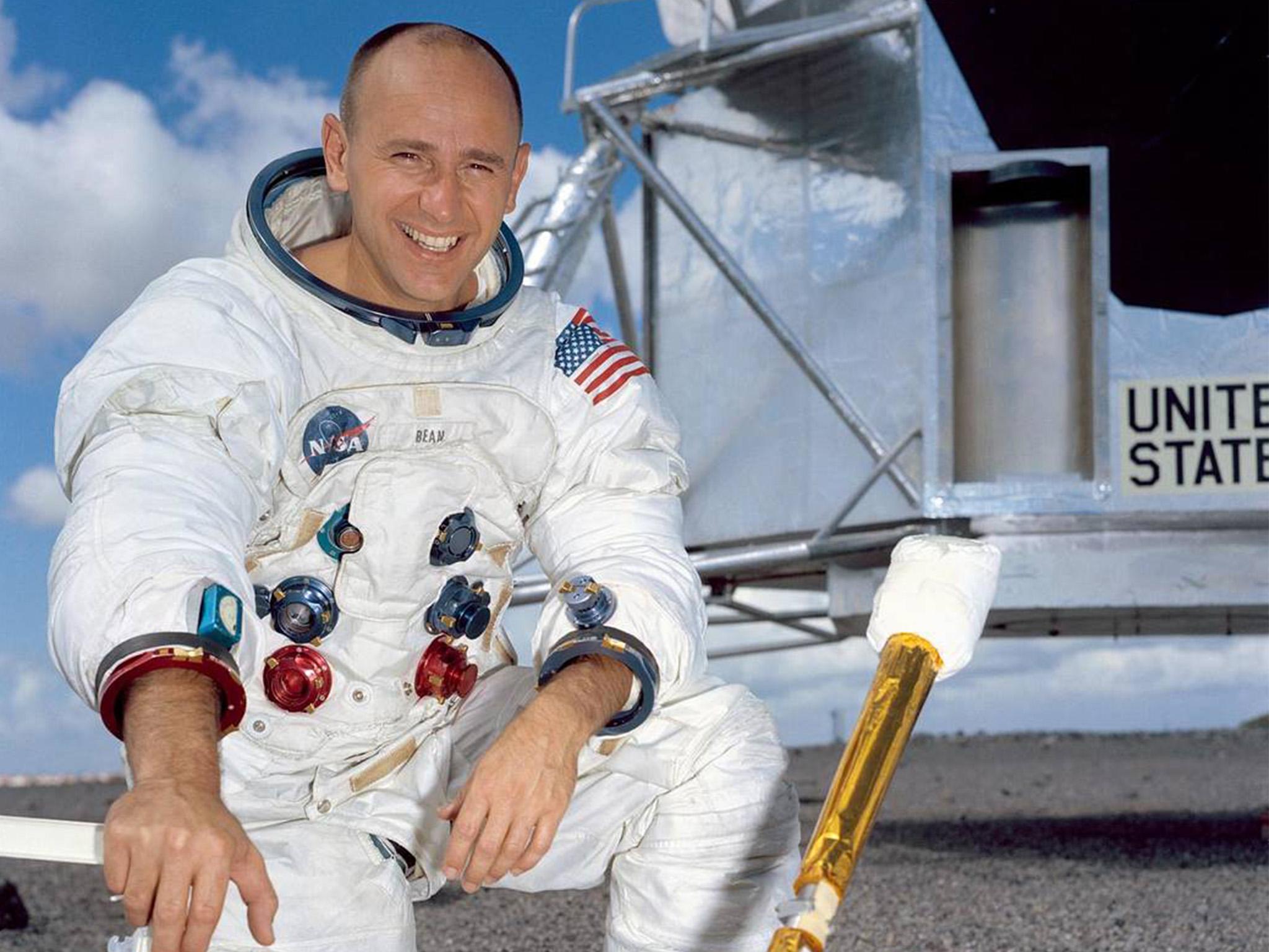 Astronaut Alan Bean poses for a portrait in front of a mock-up of the Lunar Module
