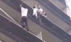 Hero climbs up Paris building to save child dangling from balcony