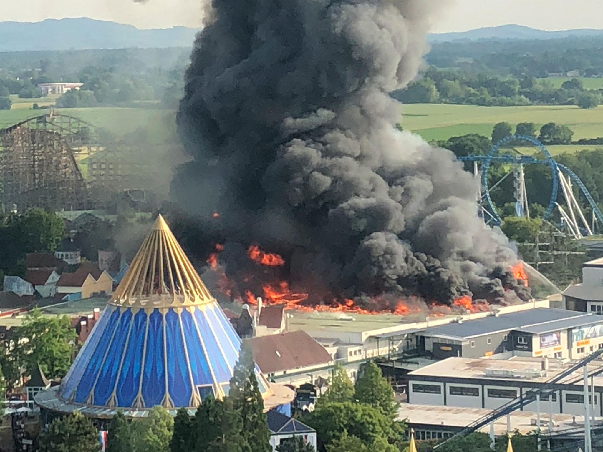 A black column of smoke rises from a burning warehouse at the Europa-Park in Rust, Germany.