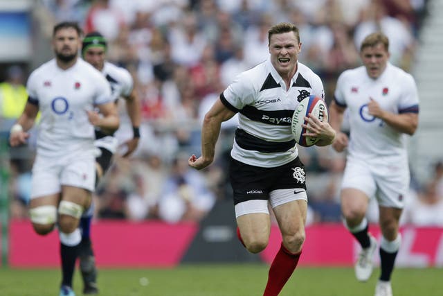 Chris Ashton scored three tries as England suffered a record defeat by the Barbarians