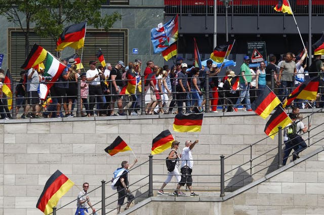 AfD sympathizers wave German flags and a WW2 German War Flag during the Right Party AfD demonstration march titled "Future Germany"  on 27 May