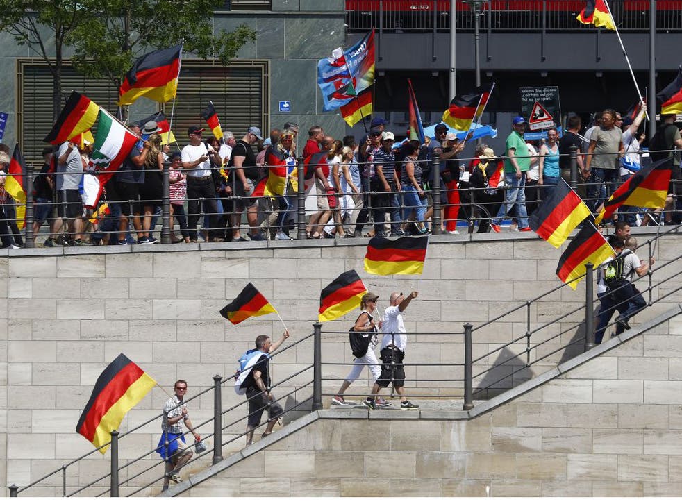 AfD sympathizers wave German flags and a WW2 German War Flag during the Right Party AfD demonstration march titled "Future Germany"  on 27 May