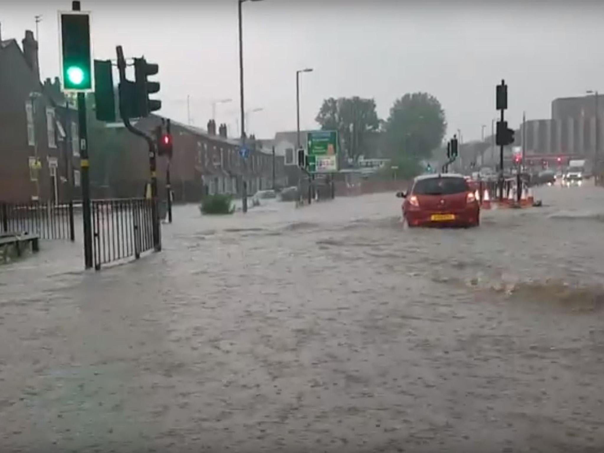 Cars plough through floodwater on Bristol Road, Birmingham