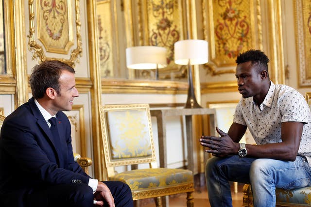 French President Emmanuel Macron meets with Mamoudou Gassama who saved a four-year-old child dangling from a fifth-floor apartment balcony.