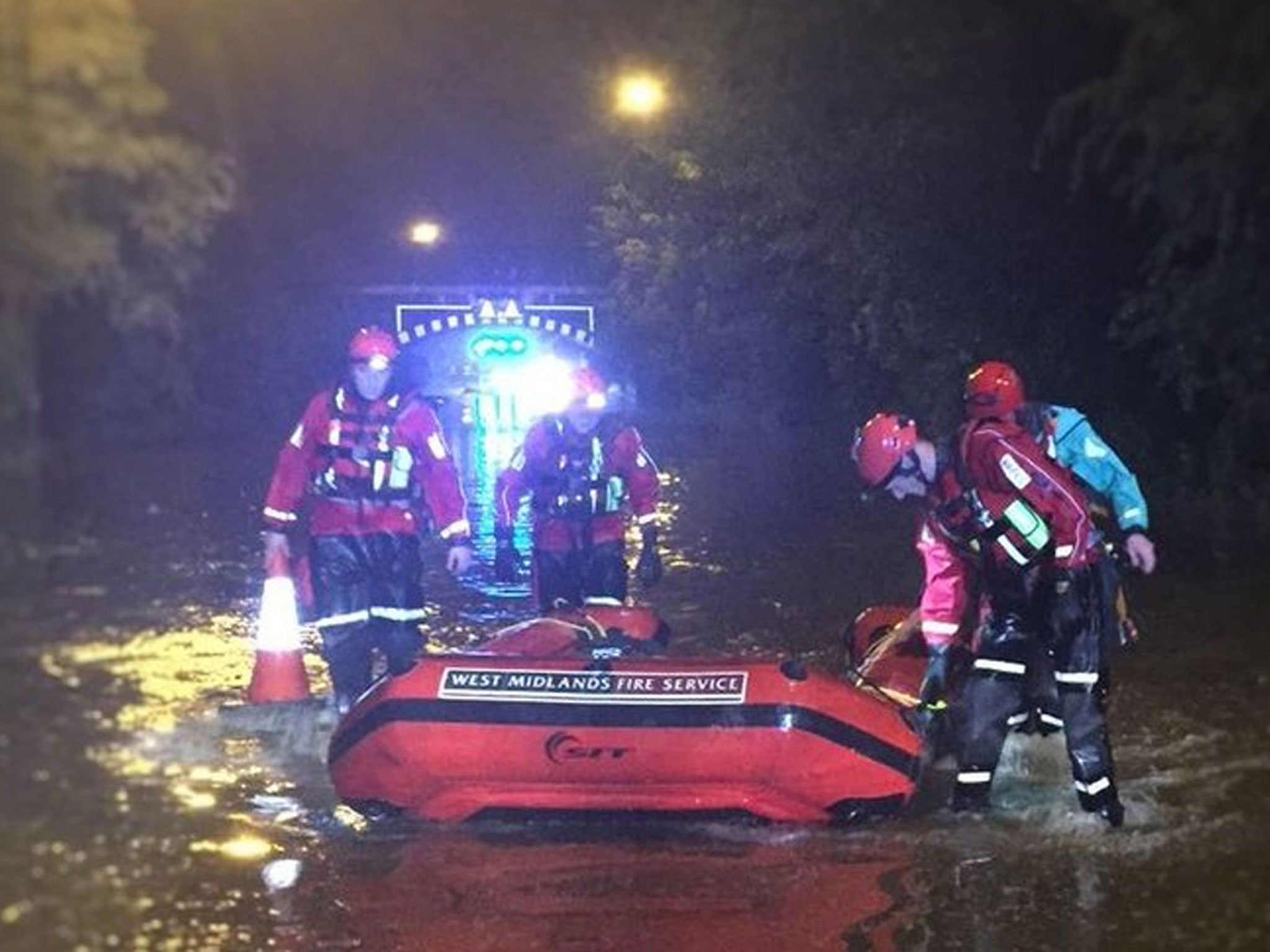 Members of the Technical Rescue Unit of West Midlands Fire Service with a boat in Birmingham after more than a month's rainfall deluged parts of Birmingham in just one hour