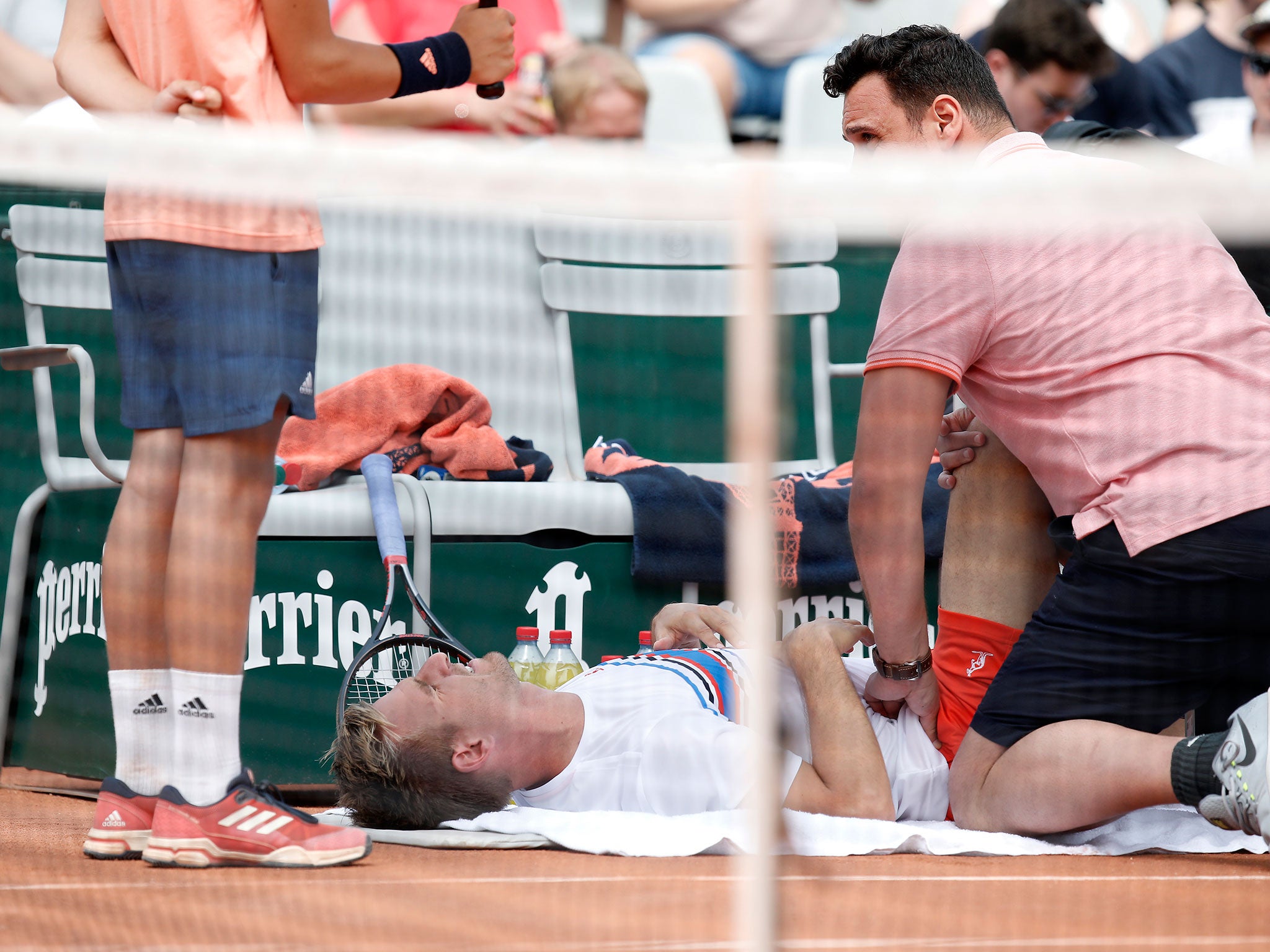 Gojowczyk receives medical assistance during the second set