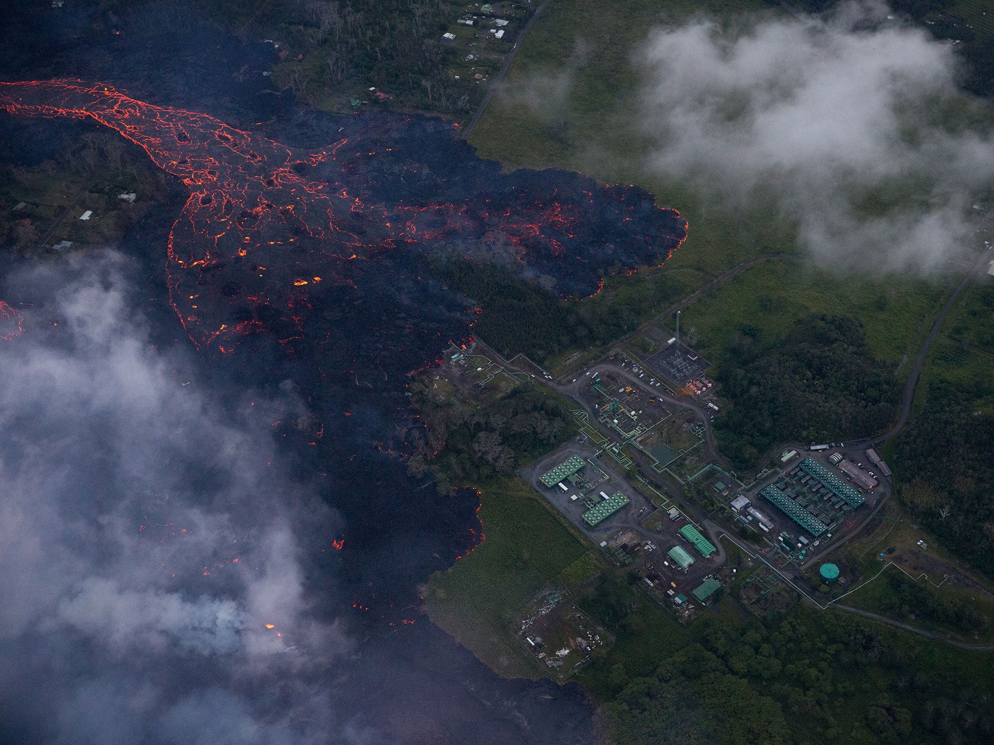 An aerial view of a flow of lava moves to the doorsteps of the Puna Geothermal Venture facility after a new fissure eruption within Leilani Estates sending a fast moving flow of lava began to consume homes and property, near Pahoa, Hawaii