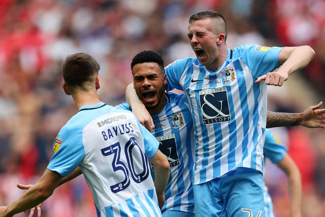 Jordan Willis celebrates with his Coventry team mates after scoring his side's first goal