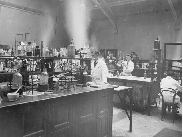 Researchers working in a chemistry laboratory in 1930