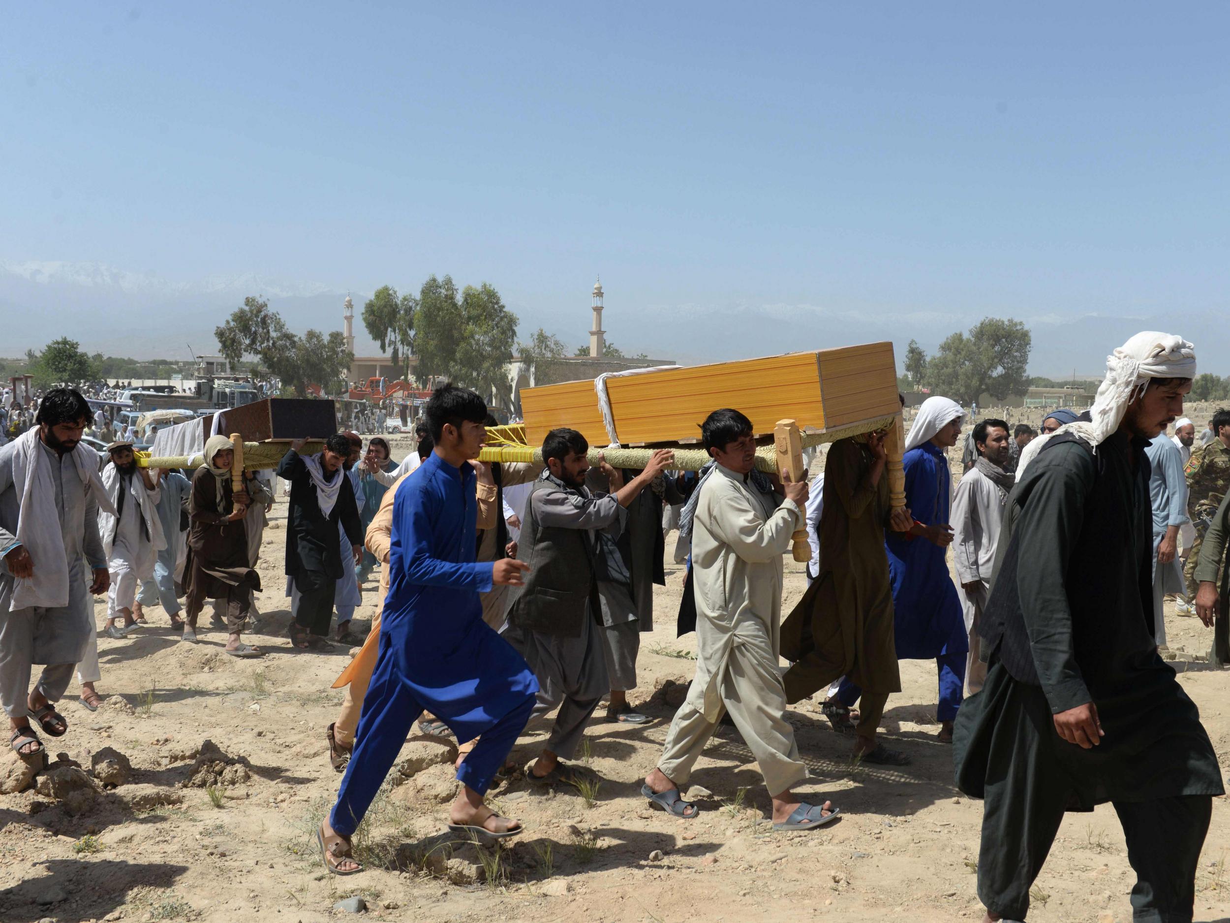 Mourners carry the coffin of one of the nine people killed during a raid by Afghan forces in the Chaparhar district of Nangarhar province