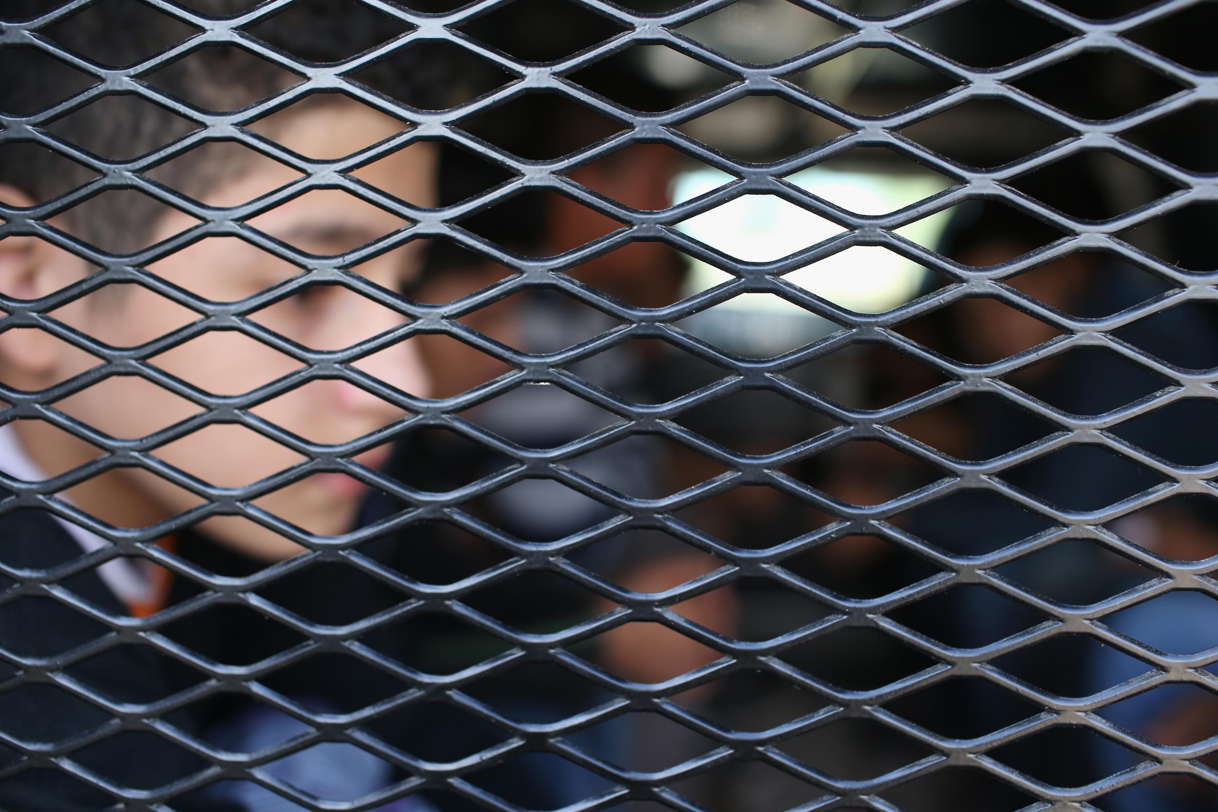 Central American immigrants wait to be transported after turning themselves in to US Border Patrol agents (John Moore/Getty)