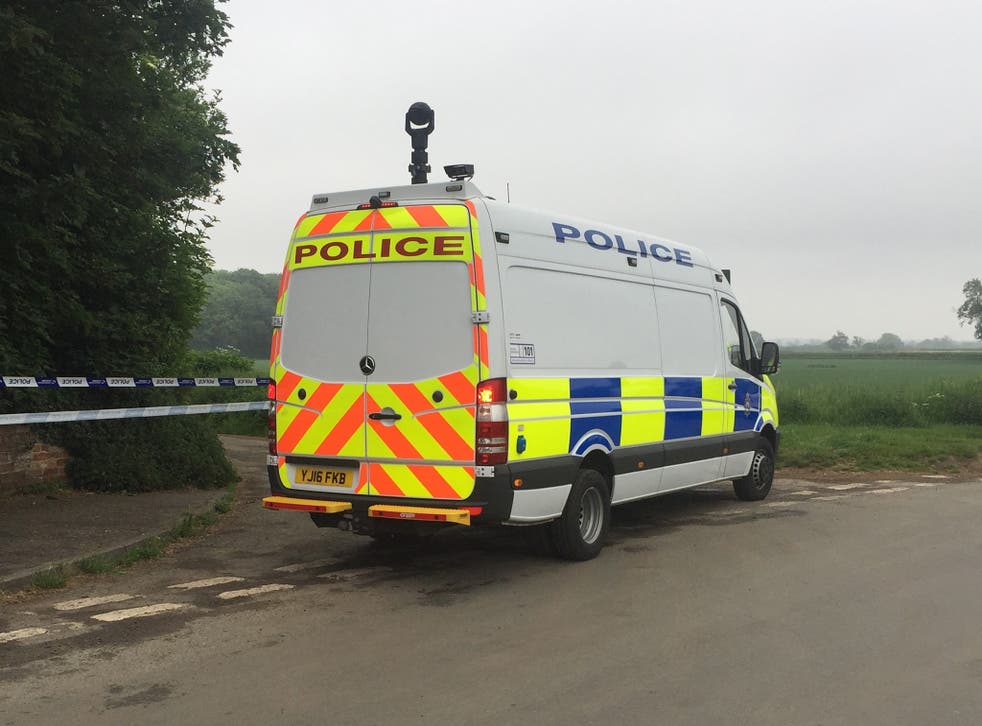 Police near the scene in Aldborough, Boroughbridge where a helicopter crashed in a field
