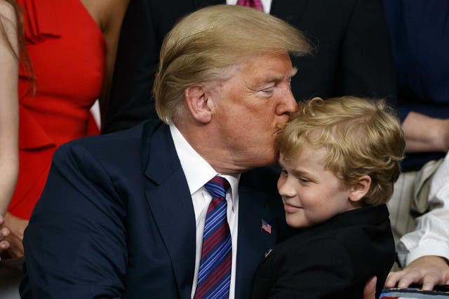 Mr Trump embraces a child with muscular dystrophy after signing the right to try law