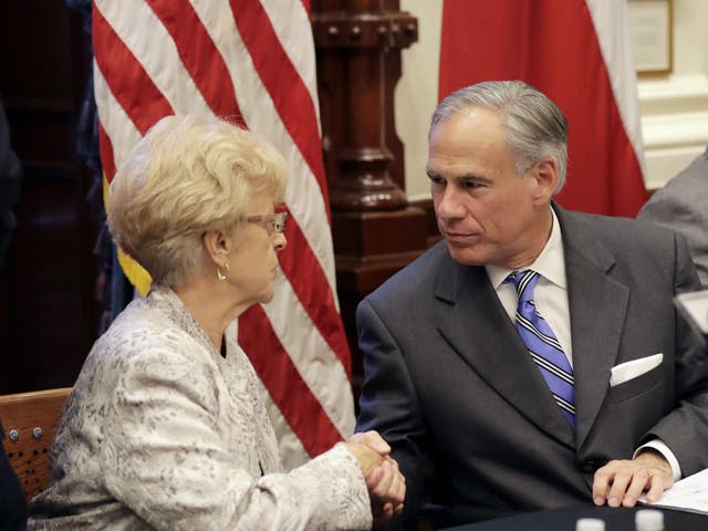 Alice Tripp of the Texas State Rifle Association, left, shakes hand with Gov Greg Abbott following a roundtable discussion to address safety and security at Texas schools