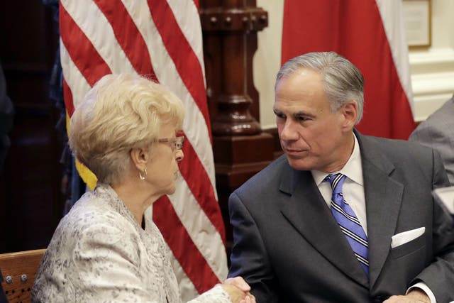 Alice Tripp of the Texas State Rifle Association, left, shakes hand with Gov Greg Abbott following a roundtable discussion to address safety and security at Texas schools