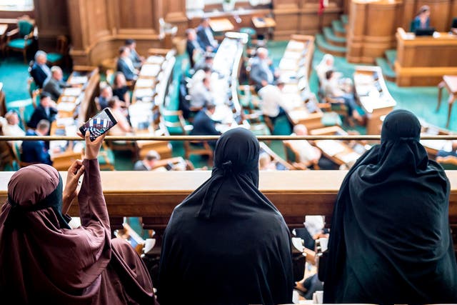 Women wearing niqab sit in the audience at the Danish Parliament in Copenhagen