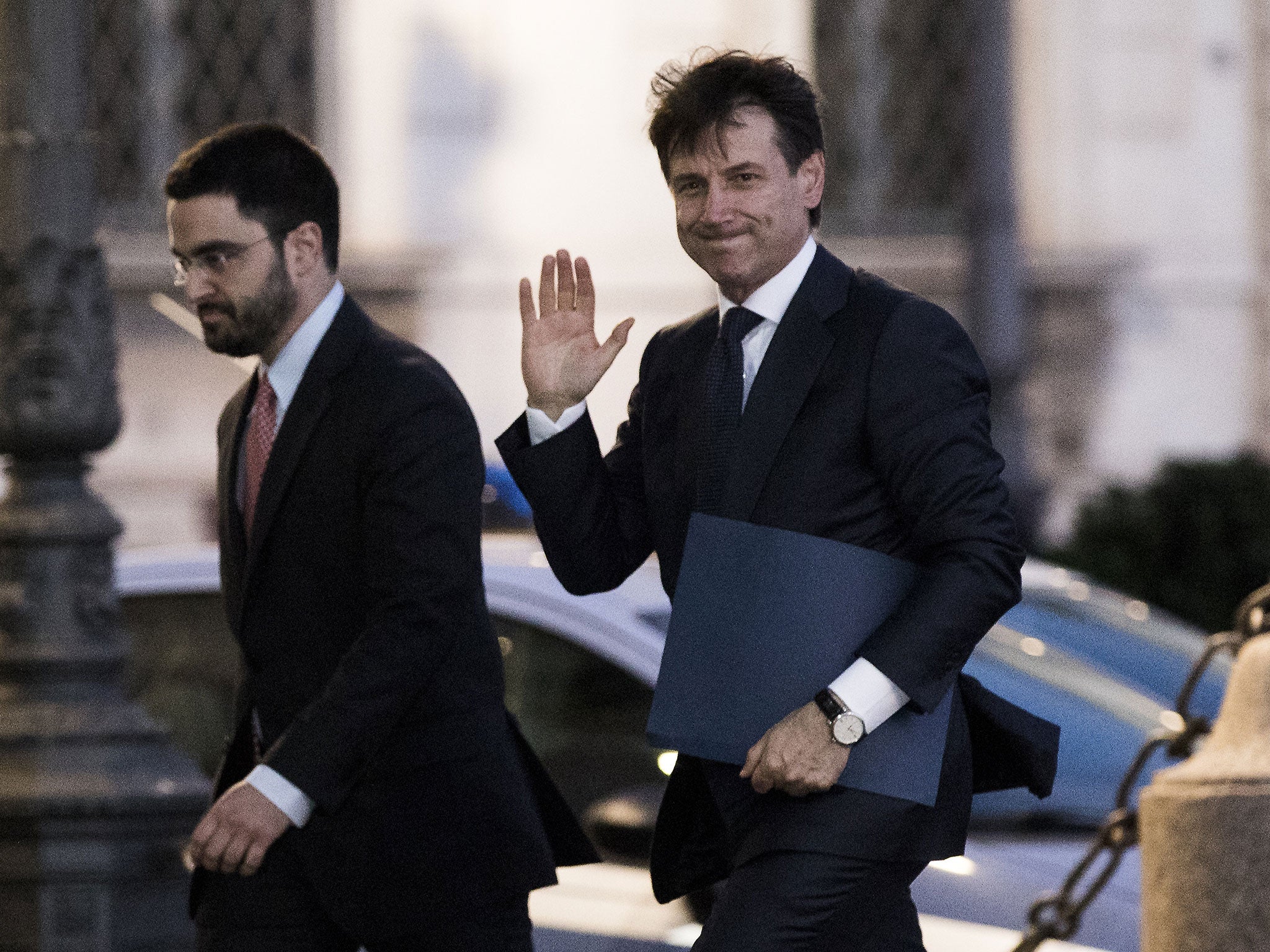 Giuseppe Conte (right) enters Italy's presidential palace on Thursday evening to receive a mandate to form a government