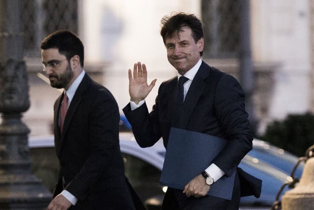 Giuseppe Conte (right) enters Italy's presidential palace on Thursday evening to receive a mandate to form a government
