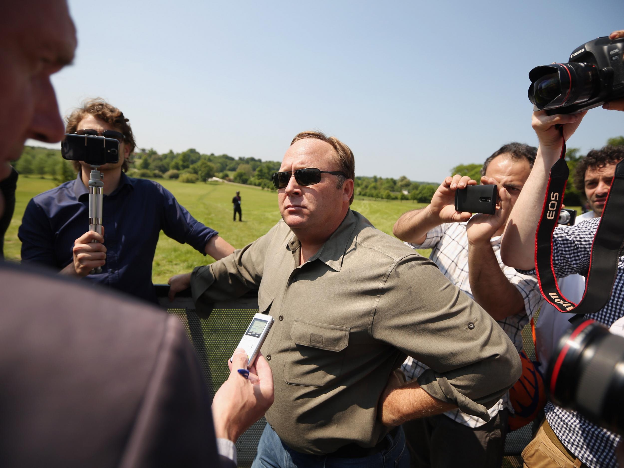 US alt-right radio host Alex Jones addressing the media at a protester encampment outside The Grove hotel in Watford, then hosting the annual Bilderbergconference, on 6 June 2013 (OliScarff/Getty)