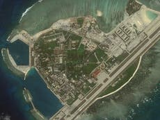 China threatens to further build up man-made islands in disputed sea