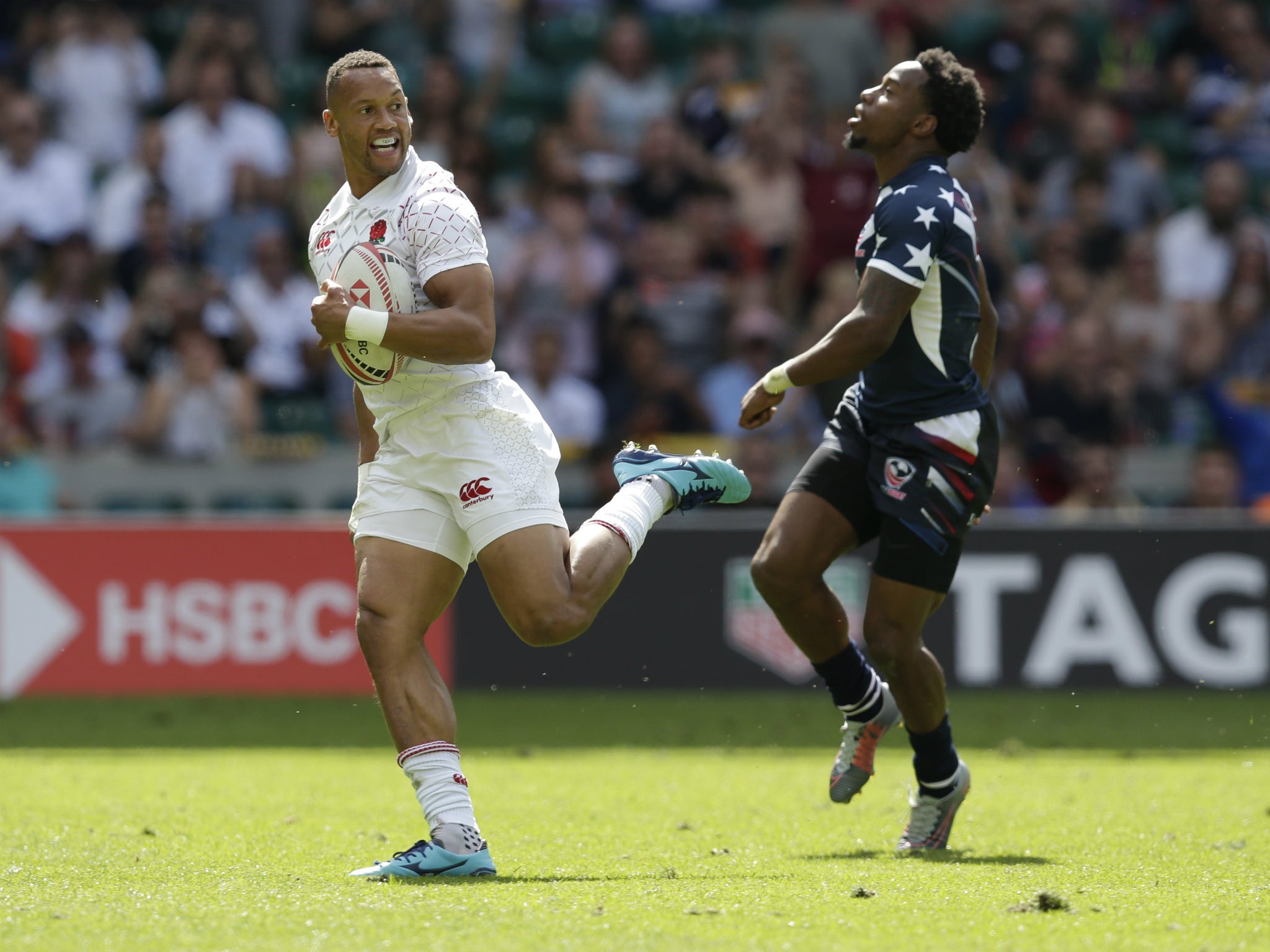 Dan Norton fends off Carlin Isles to score one of two tries against the United States at the London Sevens