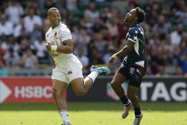 Dan Norton fends off Carlin Isles to score one of two tries against the United States at the London Sevens