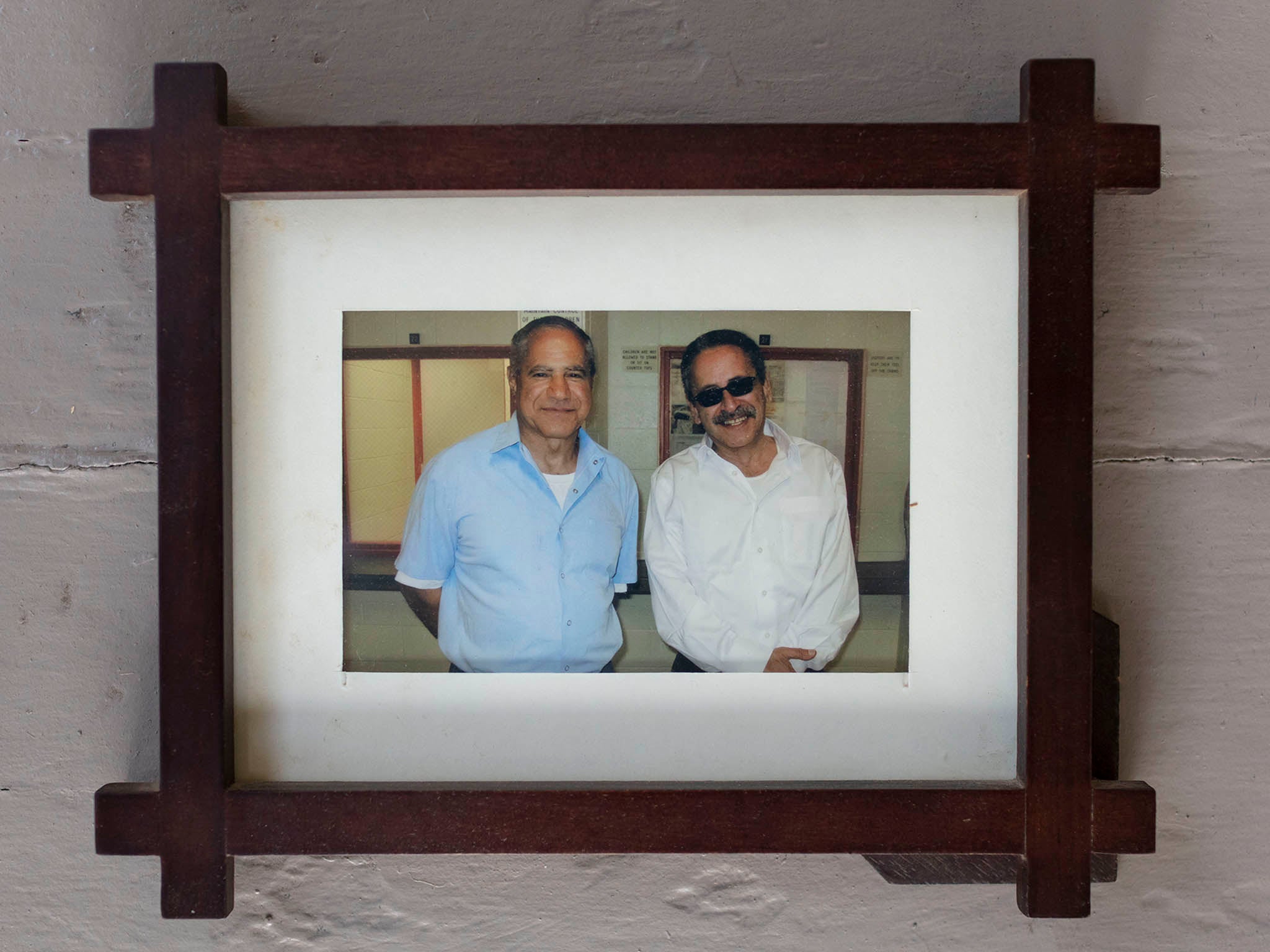 A photo of Sirhan (left) and Munir on a wall at the family home (Philip Cheung/Washington Post)