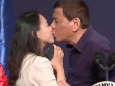Anger as Philippine leader pressures worker into kissing him on lips