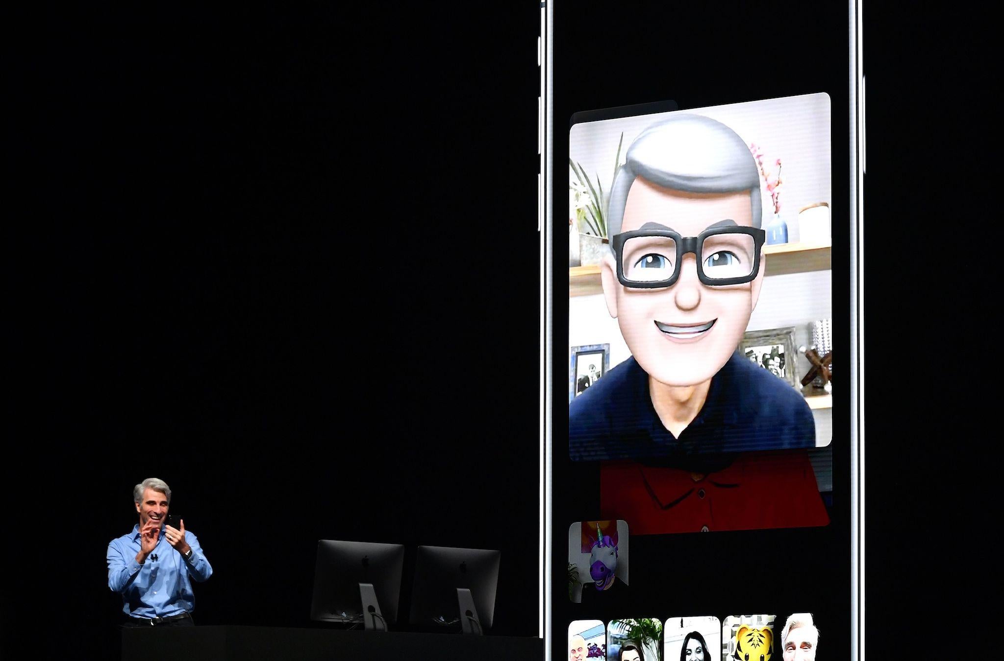Apple CEO Tim Cook (L) speaks using his Memoji during a group FaceTime call on stage during Apple's Worldwide Developer Conference (WWDC) at the San Jose Convention Centerin San Jose, California