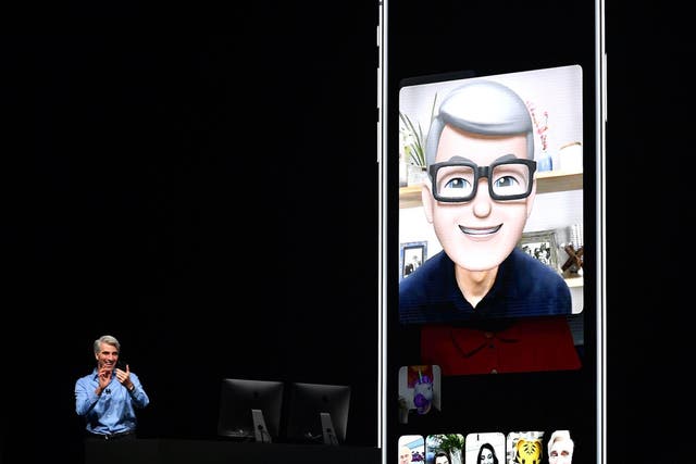 Apple CEO Tim Cook (L) speaks using his Memoji during a group FaceTime call on stage during Apple's Worldwide Developer Conference (WWDC) at the San Jose Convention Centerin San Jose, California