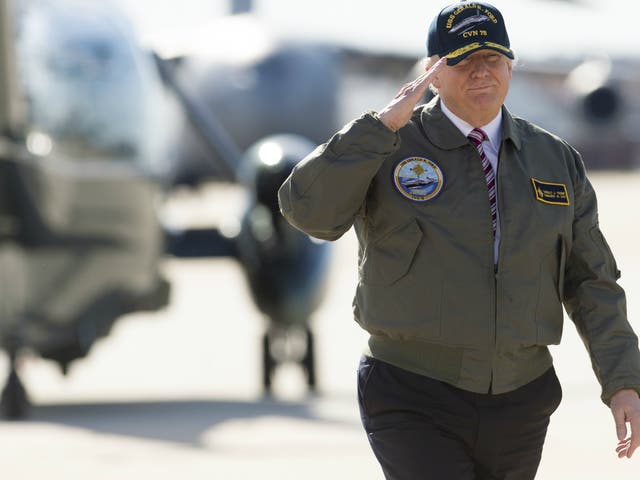 US President Donald Trump salutes as he walks to Air Force One prior to travelling to Newport News, Virginia, in March 2017 to visit the pre-commissioned USS Gerald R. Ford aircraft carrier.
