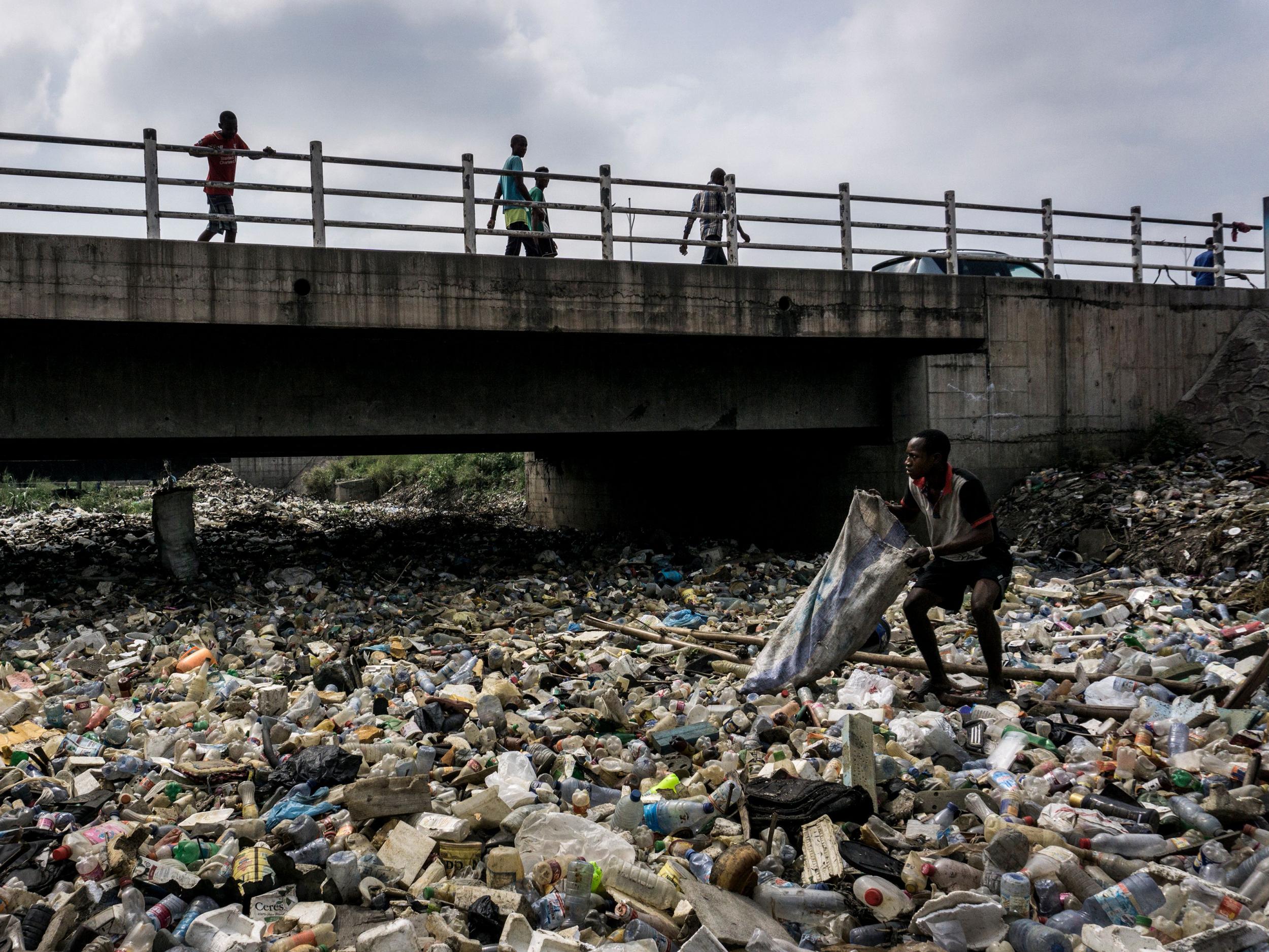 Plastic bottles completely cover the water line on the Kalamu River, which runs through the centre of Kinshasa in the Democratic Republic of the Congo
