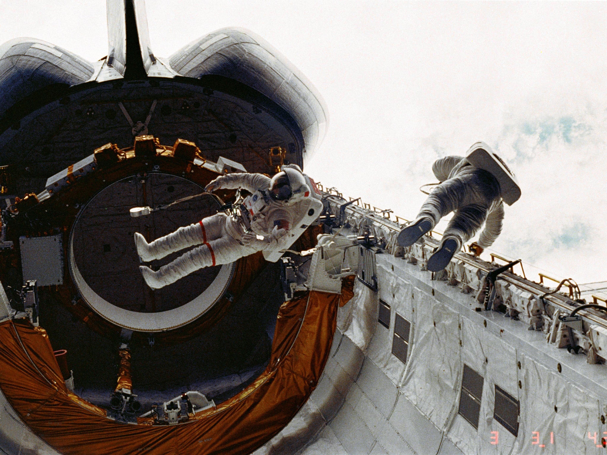 Don Peterson, right, floats in the cargo bay of the space shuttle Challenger in 1983
