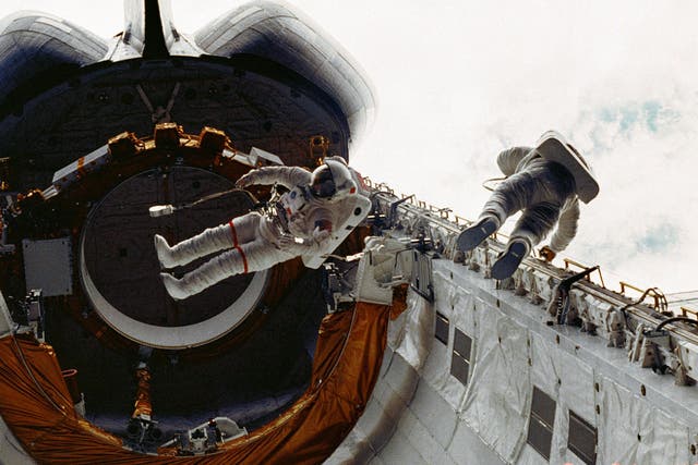 Don Peterson, right, floats in the cargo bay of the space shuttle Challenger in 1983