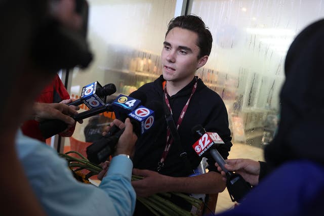 David Hogg speaks to the media before particpating in a 'die'-in' protest in a Publix supermarket